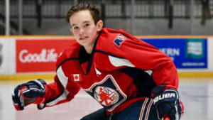 Noah Dugas skating with hockey stick