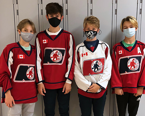Noah-Dugas-friends-from-school-1 Noah's friends wearing their hockey jerseys in front of school lockers