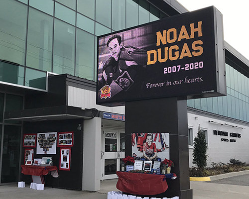 Noah-Dugas-memorial-rink-1 A memorial set up in front of a North Bay rink